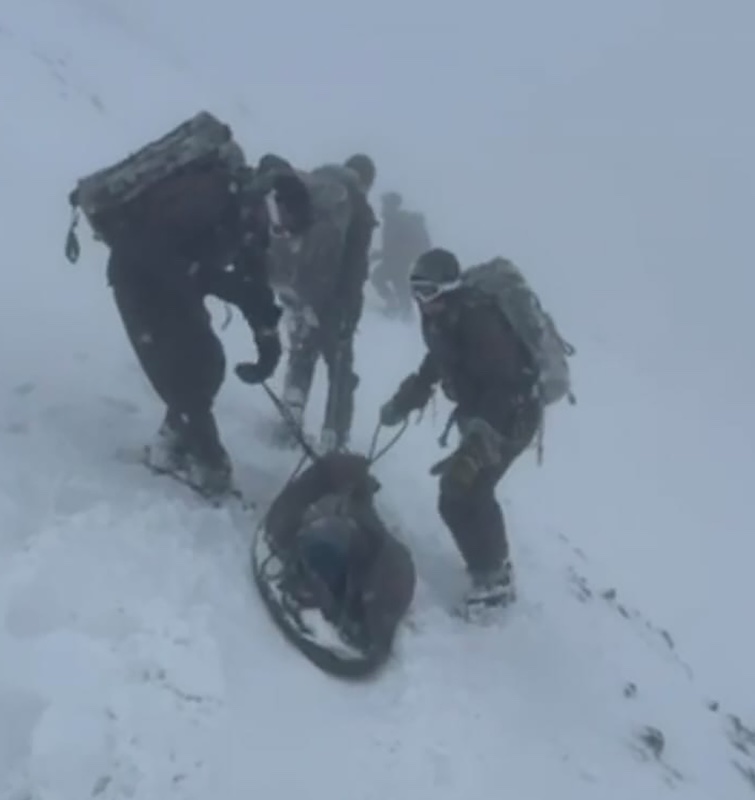Marines on top of Ben Nevis in terrible conditions rescuing stranded climber